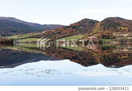 Peaceful autumn Norwegian landscape featuring a calm lake 128053411