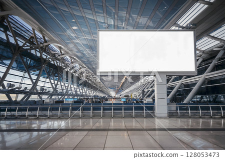 Large white billboard is in the middle of a large airport 128053473