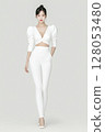 Woman in a white outfit is wearing white pants and a white top 128053480