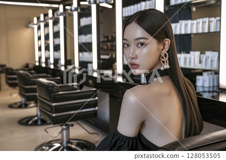 Woman is sitting in a chair in a salon Woman is sitting in a chair in a salon 128053505