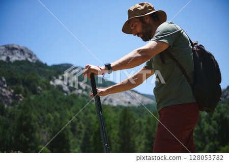 Hiker With Backpack Exploring Scenic Mountain Landscape on a Sunny Day 128053782