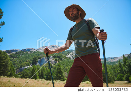 Mountain Trekking Adventure of Bearded Man with Backpack Under Sunny Skies Mountain Trekking Adventure of Bearded Man with Backpack Under Sunny Skies 128053783