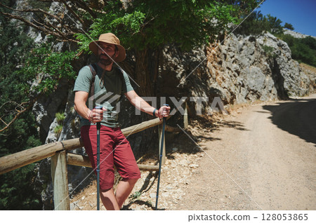 Male Hiker Exploring Rocky Mountain Trail on a Bright Summer Day Male Hiker Exploring Rocky Mountain Trail on a Bright Summer Day 128053865