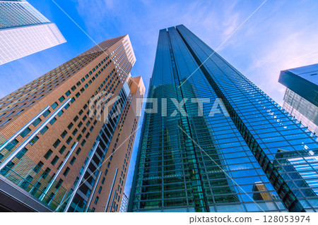 Tokyo cityscape, Japan, July 4th. View of the Shiodome office buildings, including Shiodome Tower and Nippon TV Tower. Tokyo cityscape, Japan, July 4th. View of the Shiodome office buildings, including Shiodome Tower and Nippon TV Tower. 128053974