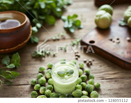 Fresh green smoothie on a rustic wooden 128055112