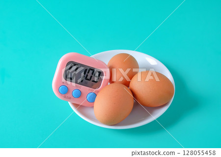 Brown egg boiled with Egg timer,Kitchen tool. Brown egg boiled with Egg timer,Kitchen tool. 128055458