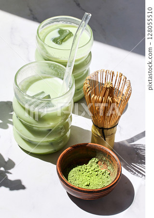 Iced Matcha Refreshment. Refreshing iced matcha drinks with a bamboo whisk and matcha powder 128055510