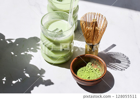Iced Matcha Refreshment. Refreshing iced matcha drinks with a bamboo whisk and matcha powder 128055511