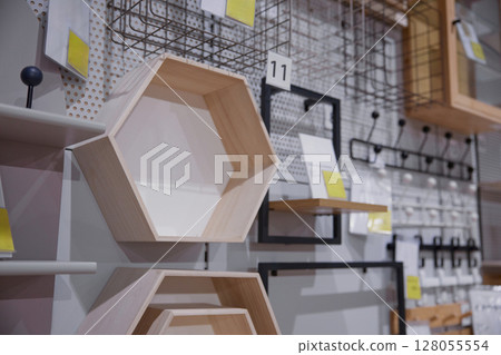 A wooden unique-shaped shelf in a furniture store 128055554