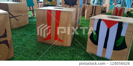 Wooden game in the form of cubes with images of cartoon characters. Concept of children's about creativity, play and public urban art, montesori, developmental eclogical toys 128056026