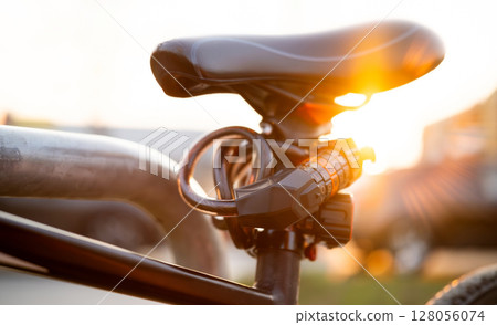Bike Seat With Code Lock Close Up At Sunset In The Park Bike Seat With Code Lock Close Up At Sunset In The Park 128056074