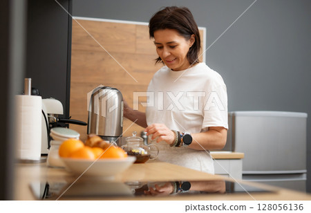 Young Woman Brewing Black Coffee In A Pot In The Kitchen In The Morning 128056136