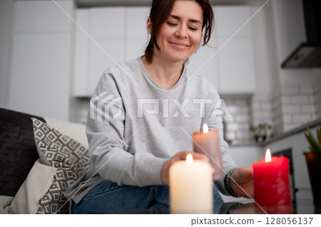 Happy Woman Lighting Aromatic Candles At Home 128056137