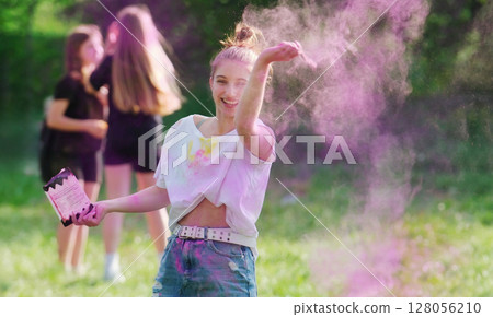 Girl Tossing Vibrant Holi Powder Paint During Holi Festival 128056210