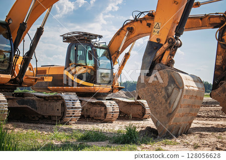 Heavy machinery at work during a sunny day on a construction site in a rural area 128056628