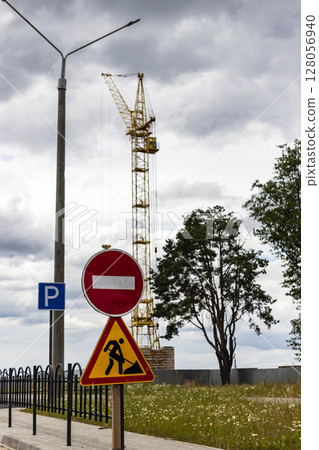 Road sign about construction and repair work. Prohibition of access to the construction site. Closed road. Construction and road works. 128056940