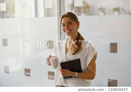 A Smiling Professional Woman in a Modern Office Setting, Radiating Positivity and Success A Smiling Professional Woman in a Modern Office Setting, Radiating Positivity and Success 128056957