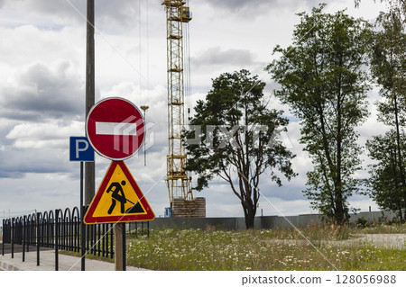 Road sign about construction and repair work. Prohibition of access to the construction site. Closed road. Construction and road works. Road sign about construction and repair work. Prohibition of access to the construction site. Closed road. Construction and road works. 128056988