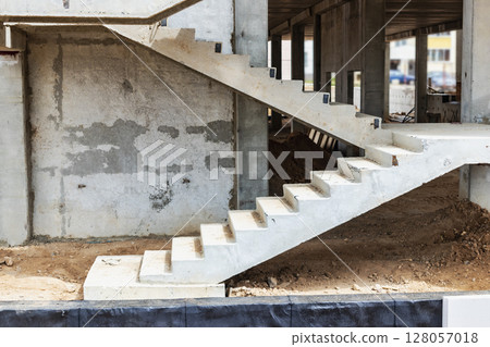 Construction of a reinforced concrete building. Elements of a concrete house. Structural elements. Construction site. Foundations and grillages. 128057018