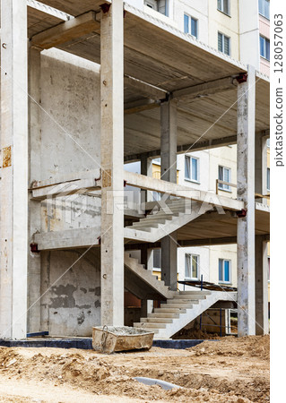 Construction of a reinforced concrete building. Elements of a concrete house. Structural elements. Construction site. Foundations and grillages. Construction of a reinforced concrete building. Elements of a concrete house. Structural elements. Construction site. Foundations and grillages. 128057063