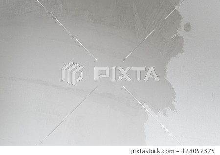 Stressful ceiling water damage shows peeling cracked paint from leak. old house structure needs urgent renovation and home improvement to fix damp plaster wall 128057375