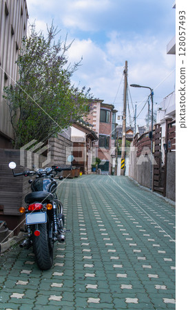 Motorcycle on a Paved Alley in Bukchon Hanok Village, Seoul. Motorcycle on a Paved Alley in Bukchon Hanok Village, Seoul. 128057493