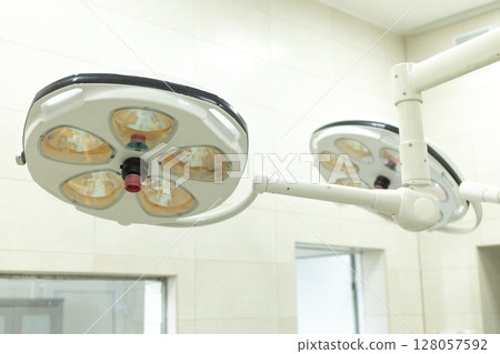 surgical lamp in the operating room above the operating table 128057592