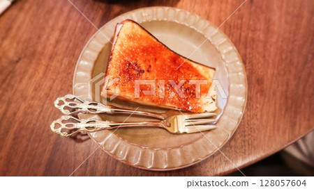 baked basque cheese cake looks like creme brulee custard cake with caramelized top  128057604