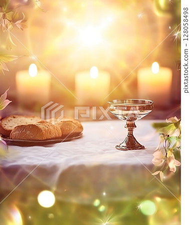 A table with a glass of water, a plate of bread, and three candles 128058498