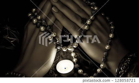 A woman's hands are clasped together with a necklace of pearls 128058721