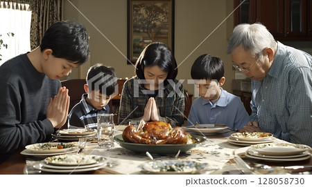 A family is gathered around a table with a turkey and a glass of water 128058730