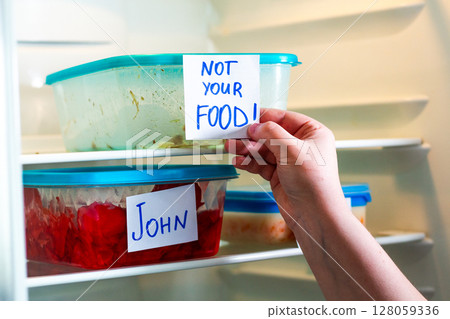 Sarcastic sticker warnings Not Your Food and Do Not Touch on lunch boxes in shared office refrigerator. Office life. Sarcastic sticker warnings Not Your Food and Do Not Touch on lunch boxes in shared office refrigerator. Office life. 128059336