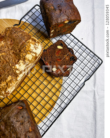 Homemade bread loaf without yeast or gluten in woman hands. Image for health conscious audiences and natural food themes. 128059345
