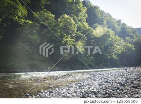A small waterfall among the rocks on the mountain river in Georgia. Panoramic picture. 128059500