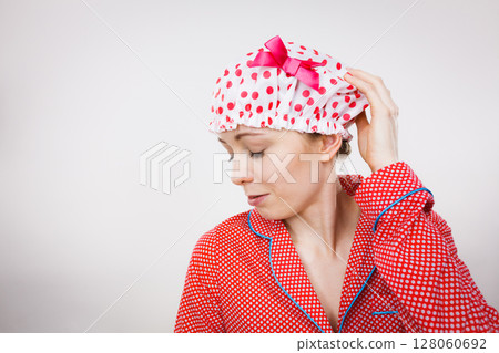 Funny woman wearing pajamas and bathing cap Funny woman wearing pajamas and bathing cap 128060692