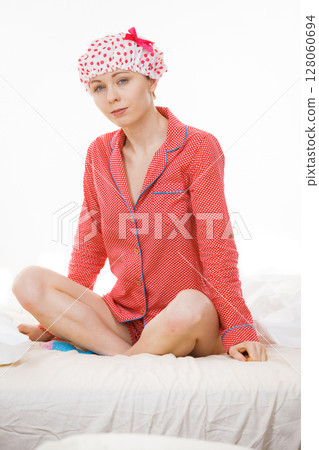 Funny woman wearing pajamas and bathing cap Funny woman wearing pajamas and bathing cap 128060694