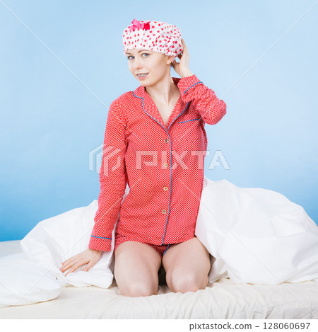 Funny woman wearing pajamas and bathing cap Funny woman wearing pajamas and bathing cap 128060697