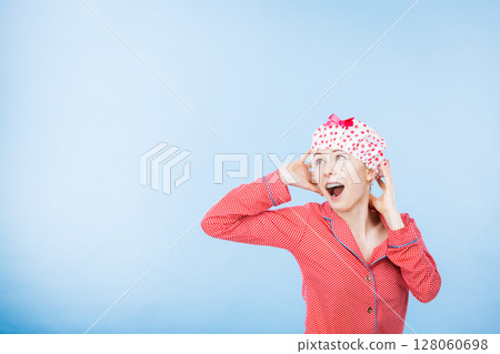 Funny woman wearing pajamas and bathing cap Funny woman wearing pajamas and bathing cap 128060698