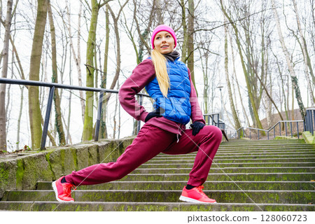 Sporty girl stretching outdoor in park. Sporty girl stretching outdoor in park. 128060723