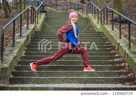 Woman wearing sportswear exercising outside during autumn Woman wearing sportswear exercising outside during autumn 128060724