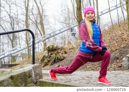 Sporty girl stretching outdoor in park. Sporty girl stretching outdoor in park. 128060726
