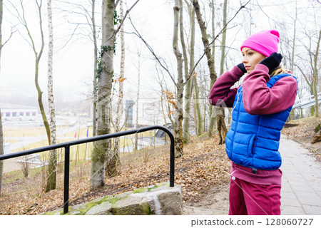Teenage sporty girl listening to music outdoor. Teenage sporty girl listening to music outdoor. 128060727