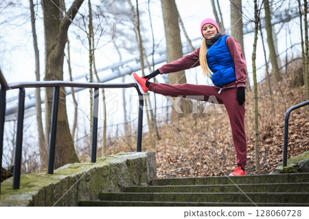 Woman wearing sportswear exercising outside during autumn Woman wearing sportswear exercising outside during autumn 128060728