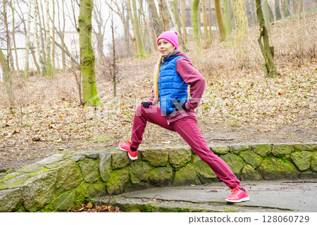 Sporty girl stretching outdoor in park. Sporty girl stretching outdoor in park. 128060729