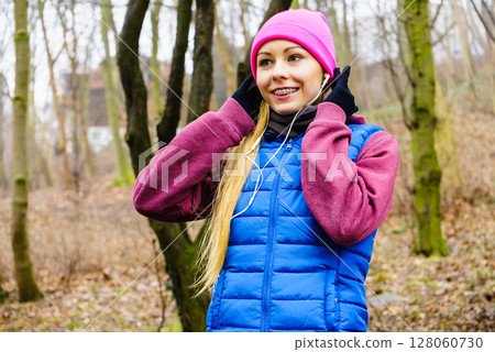 Teenage sporty girl listening to music outdoor. Teenage sporty girl listening to music outdoor. 128060730