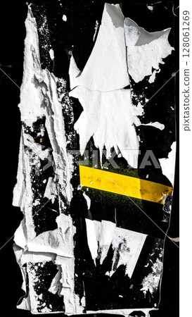 Torn White Poster with Yellow Accent on Black 128061269