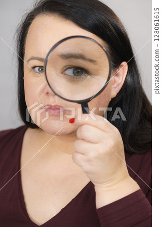 Adult woman with magnifying glass Adult woman with magnifying glass 128061615