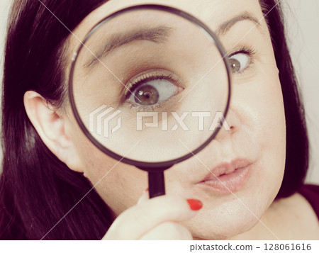 Adult woman with magnifying glass Adult woman with magnifying glass 128061616