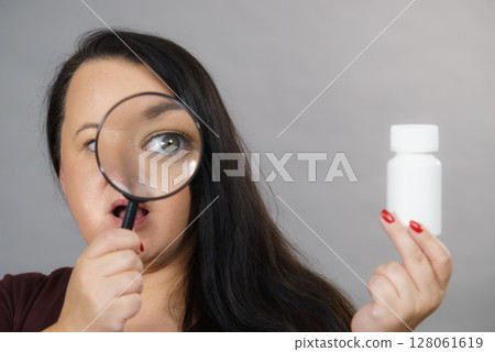 Woman investigating ingredients of medicines Woman investigating ingredients of medicines 128061619