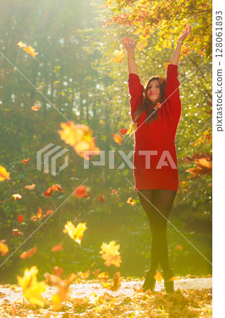Girl tossing up leaves. 128061893